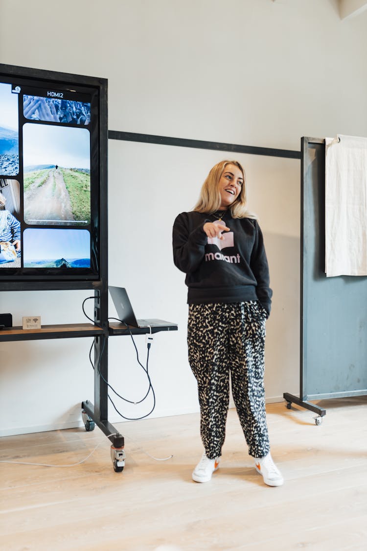 Smiling Blonde Woman Presenting