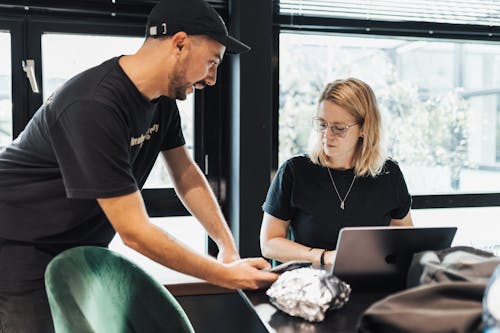 Woman and Man Working by Table