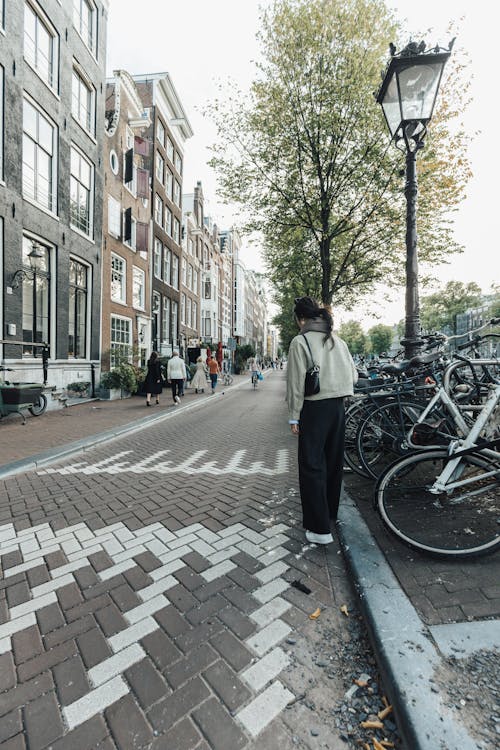 Woman Standing on a Pedestrian Street in Amsterdam 