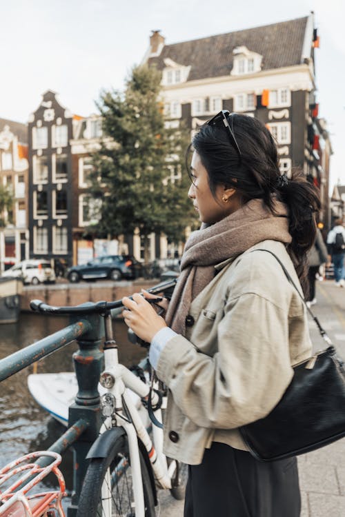 Woman Standing by Railing in Town