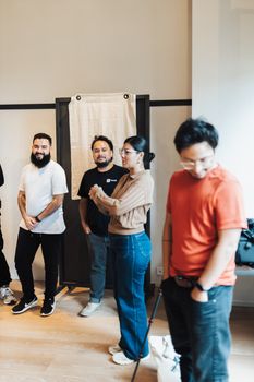 A diverse group of colleagues having a casual meeting in a modern office setting.