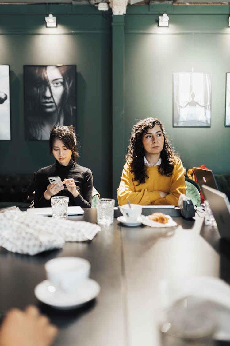 Women Sitting At A Table During A Party 