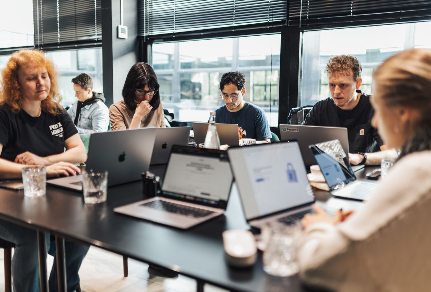 Team in a modern office workshop using laptops for business workflow training