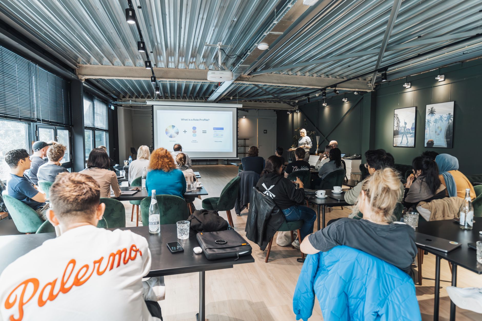 high end event planner Cairo — A diverse group attending an educational workshop indoors, focused on a presentation.