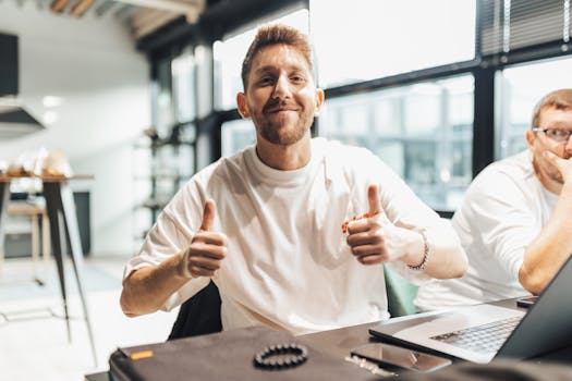 Young professionals in a modern office setting engaging in a positive discussion.