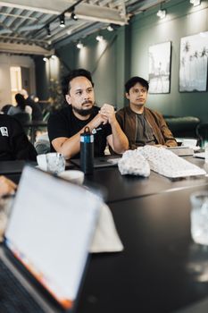 Two men in a modern office setting engaged in a collaborative meeting, fostering teamwork.