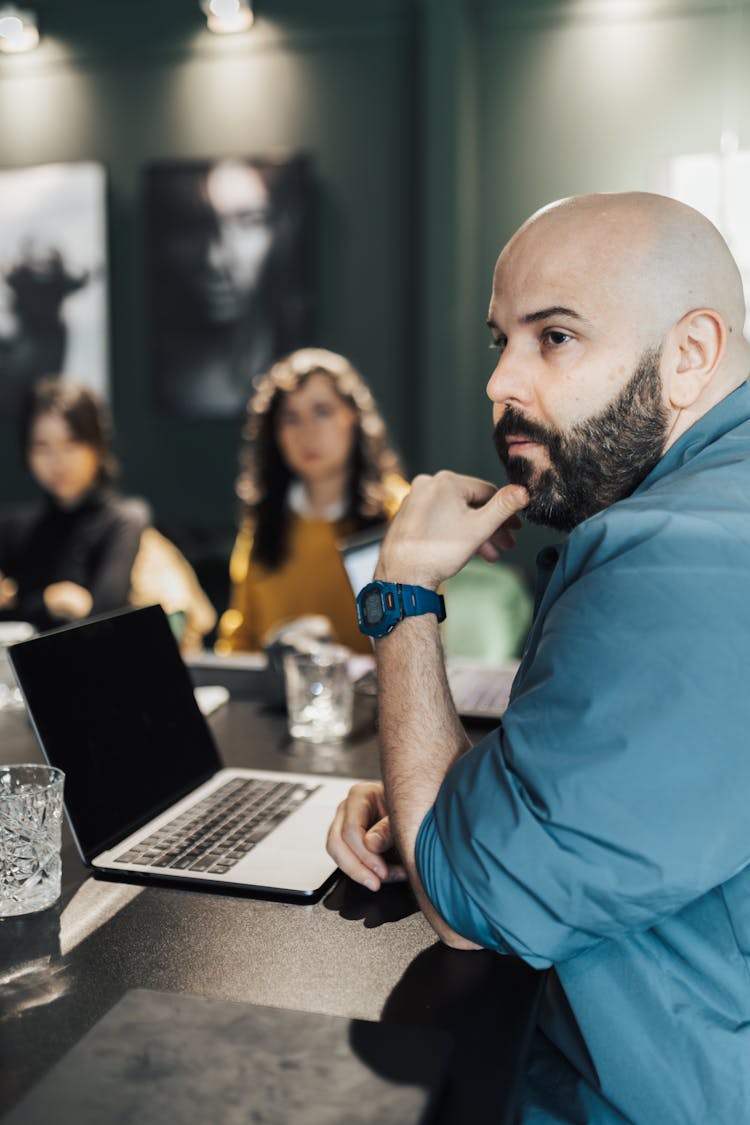 Man Sitting By A Table In A Business Meeting