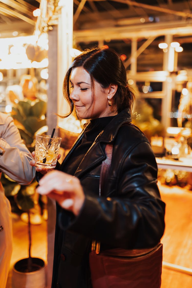 Woman Having A Drink At A Party 