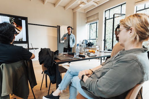 A group of professionals engaged in a dynamic presentation in a bright, modern office setting.