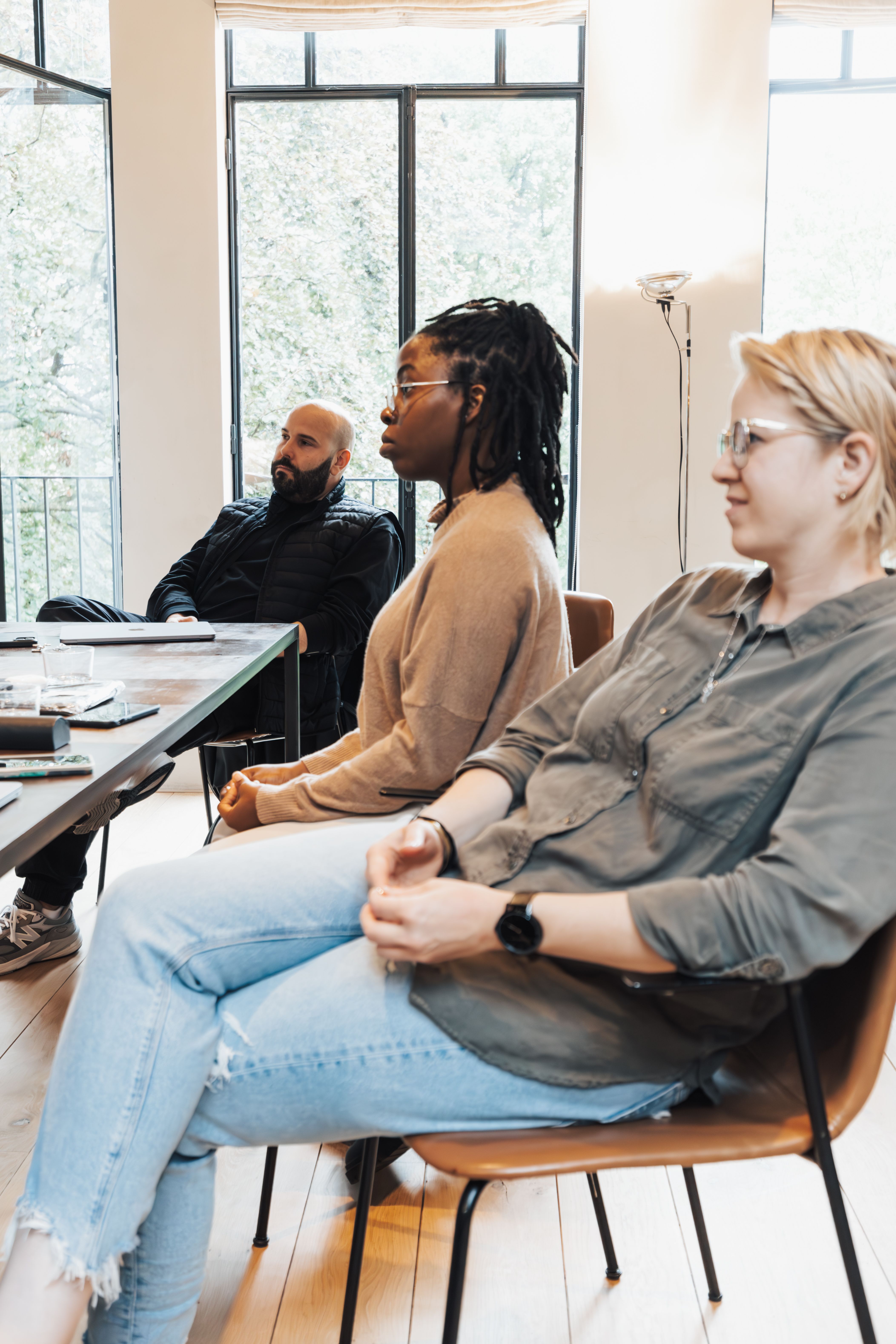 Diverse group of professionals attentively engaging in a business meeting indoors.
