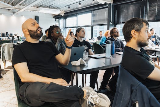 A diverse group of employees attentively participating in a collaborative team-building meeting.