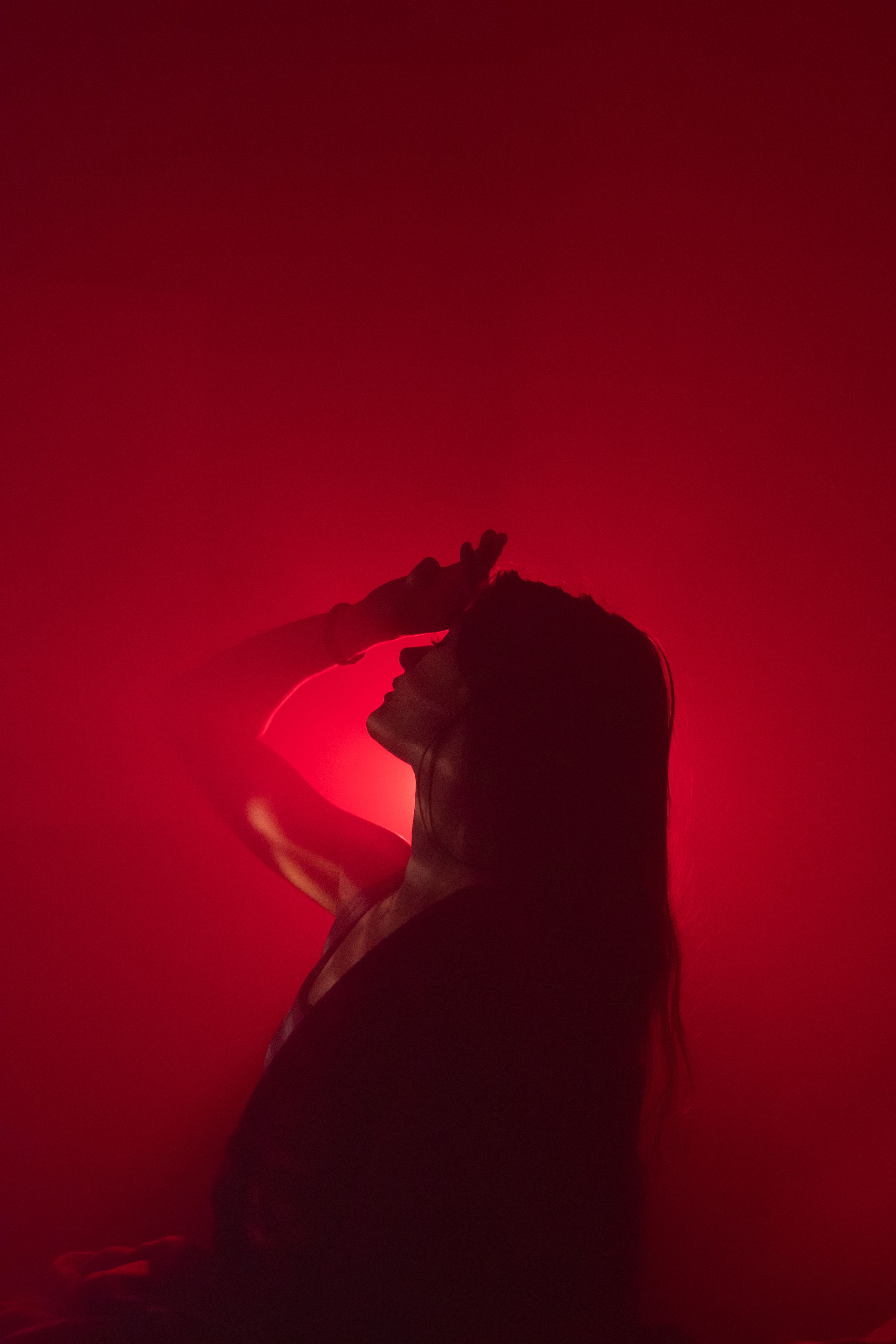 Red Exploding Mist On Person Person Touching Forehead in Red Mist · Free Stock Photo