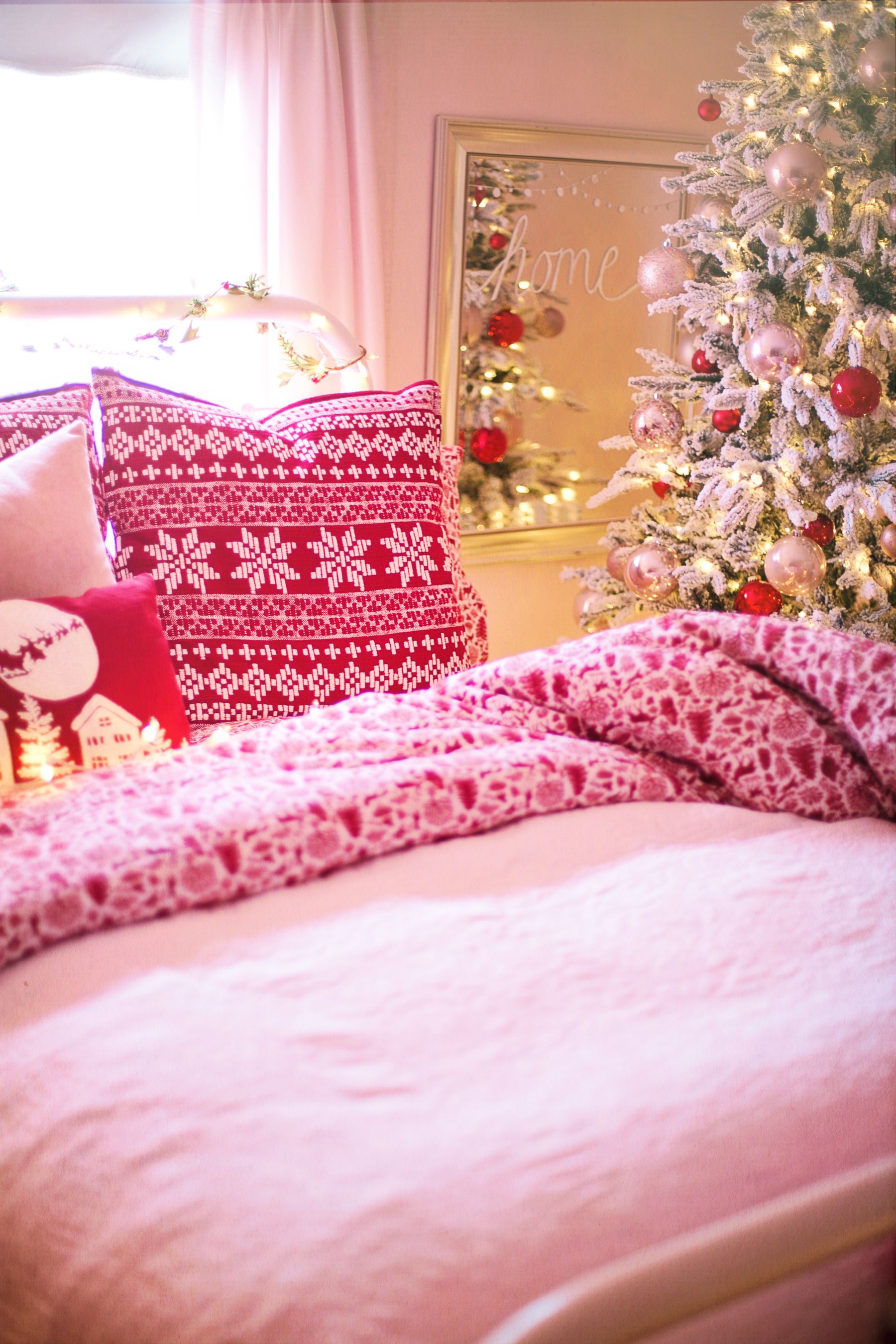 Warm bedroom with a compact Christmas tree and cozy bedding