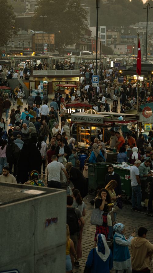Free Bustling crowd at Eminonu Square, Istanbul during sunset, showcasing urban life and local culture. Stock Photo