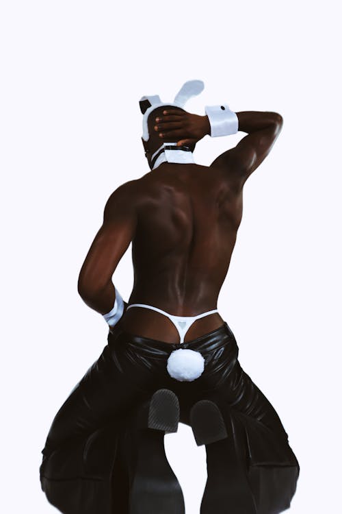 Back View of Topless Man with Rabbit Ears and Tail Kneeling