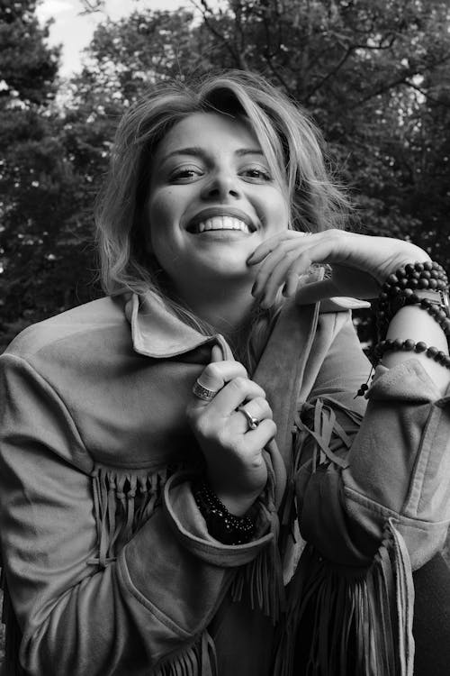 Smiling Woman Sitting in Black and White