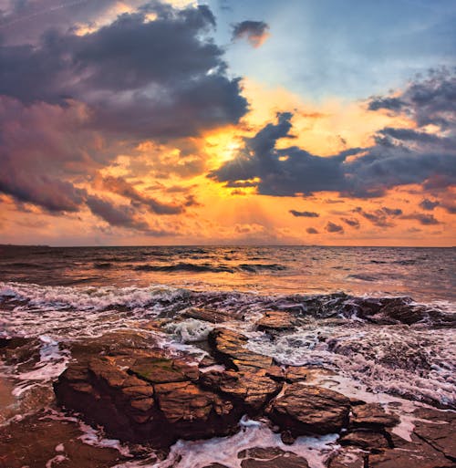 Rocks on Sea Shore at Sunset