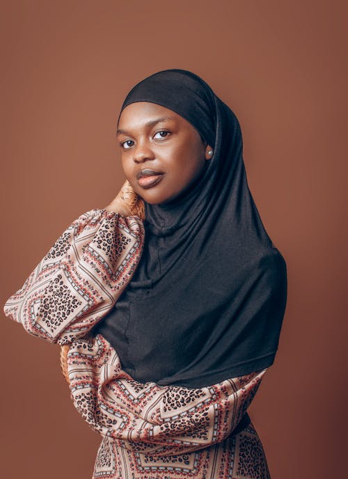 Woman with Hijab Posing Against Brown Background