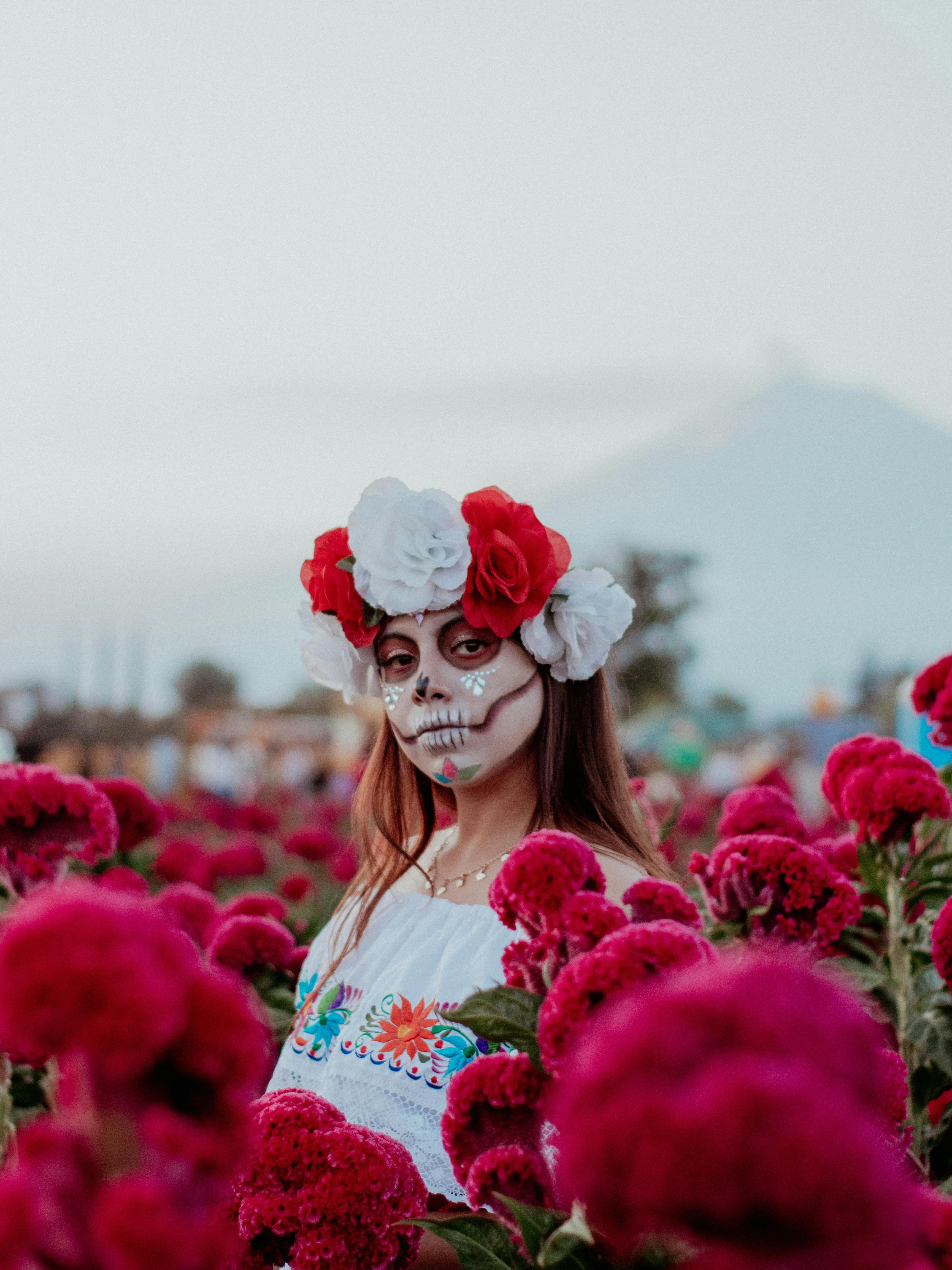 woman wearing a costume and makeup for the day of the dead in mexico