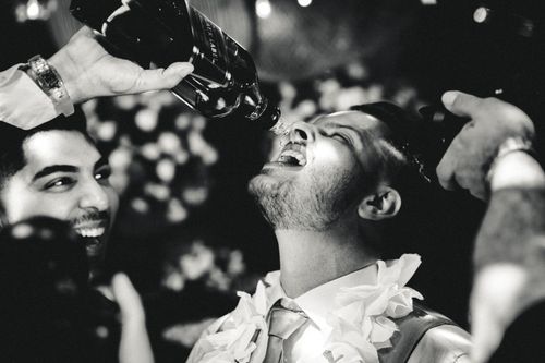 Free Dynamic black and white party scene capturing friends having fun and enjoying drinks. Stock Photo