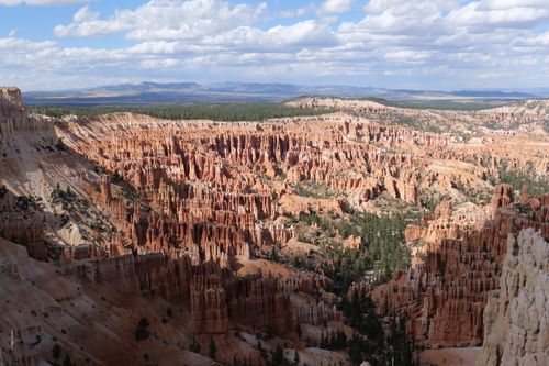 Free Dramatic aerial view of Bryce Canyon's unique hoodoo formations under a bright sky. Stock Photo