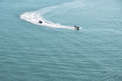 Free Jet skis creating waves on a sunny Spanish coastline, captured from above. Perfect for recreation and travel themes. Stock Photo