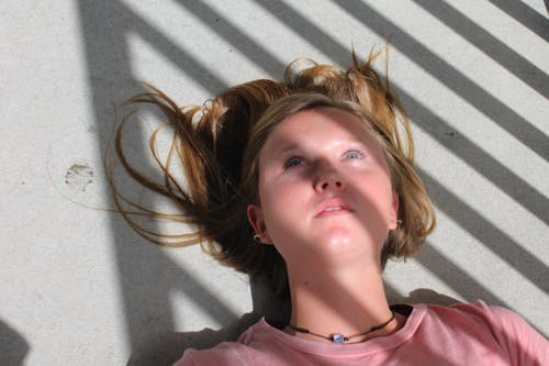 Free Woman Lying on the Floor Stock Photo