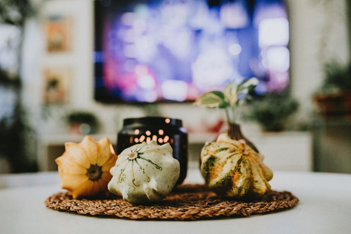 Stylish autumn decoration with pumpkins and candles in a cozy living room setting. Stock Photo.