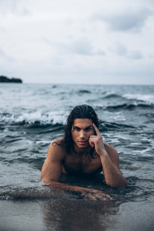 A man with long hair in the ocean