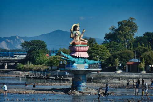 Free Statue of a goddess by the river in Haridwar, India, a scenic summer day with people around. Stock Photo