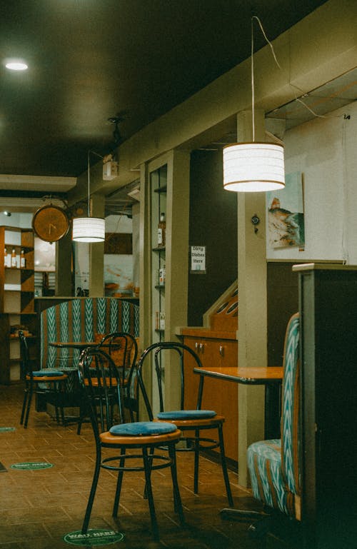 Lamp over Empty Chairs and Table in Restaurant