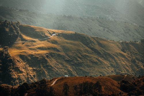 Free Experience the breathtaking aerial view of lush green hills under soft daylight, showcasing nature's beauty. Stock Photo