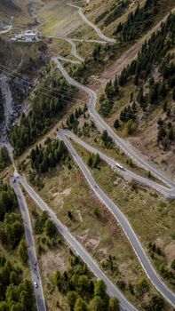 Aerial view of a winding mountain road surrounded by lush greenery, perfect for travel and adventure enthusiasts.