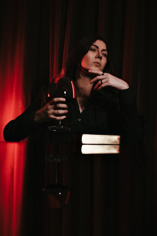 Woman Sitting with a Book and a Glass of Wine 