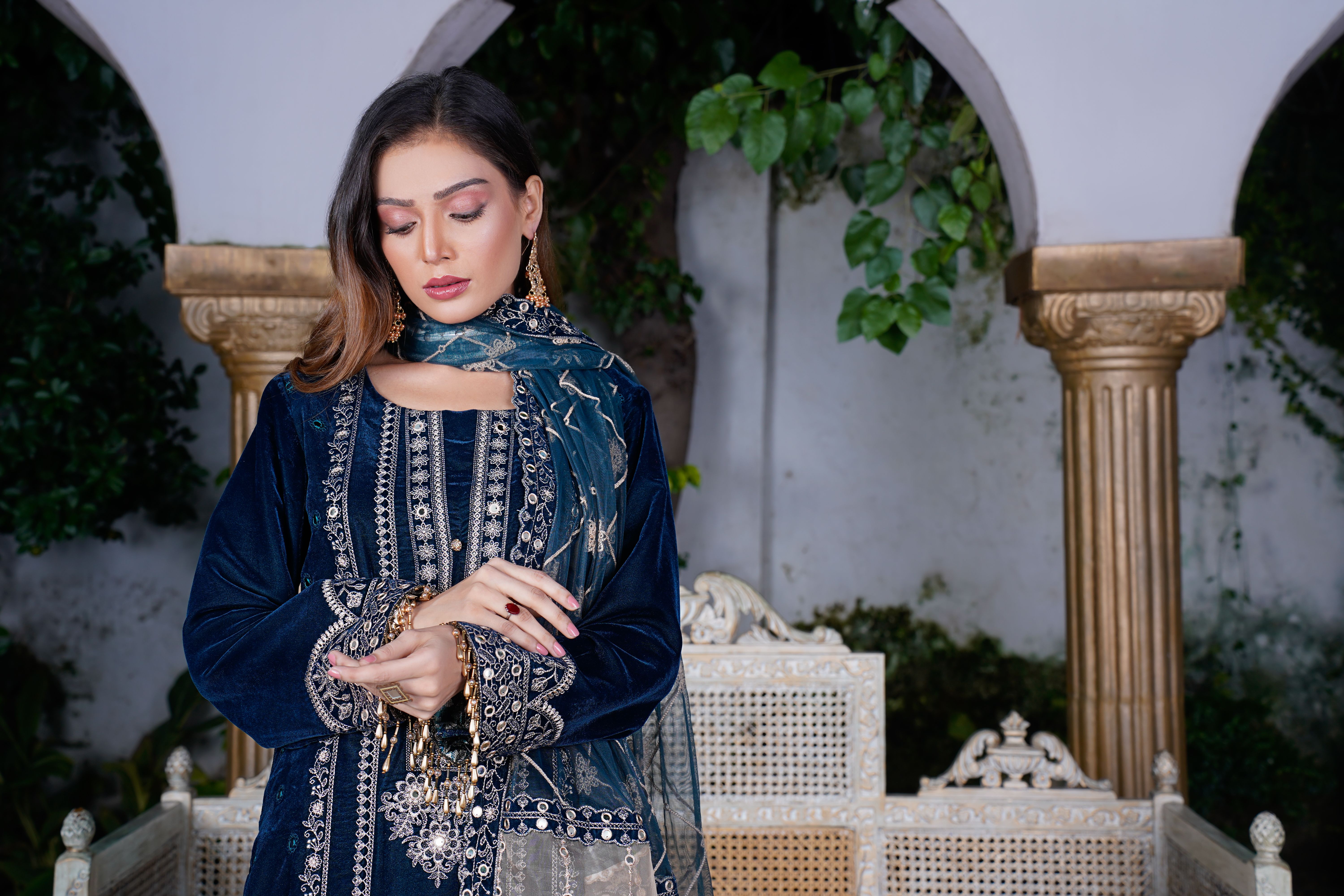 A beautiful woman in traditional Pakistani attire poses elegantly in Lahore, showcasing intricate embroidery.