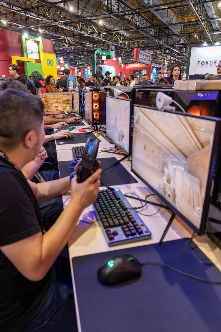 People Playing Computer Games At A Convention 