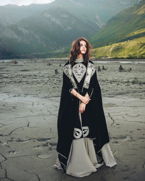 Model in Dress Standing on Dry Lake