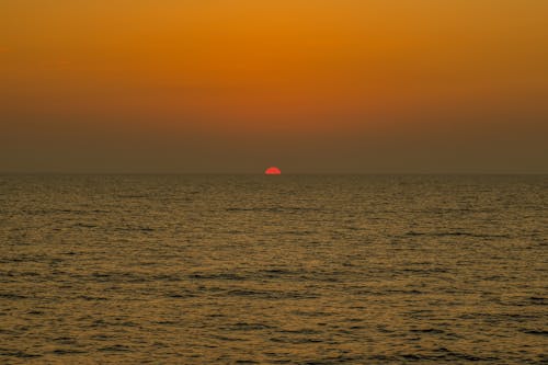 Red Sun Setting behind Ocean