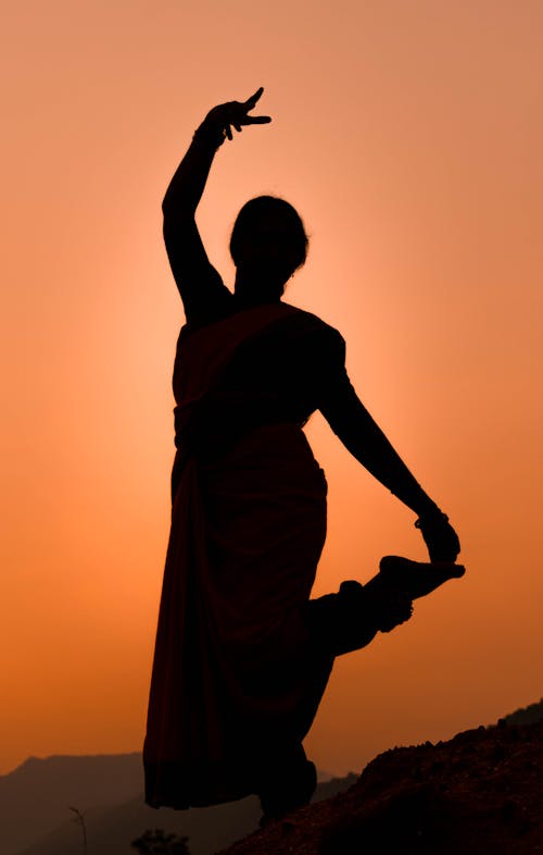 Silhouette of Posing Woman on Yellow Sky