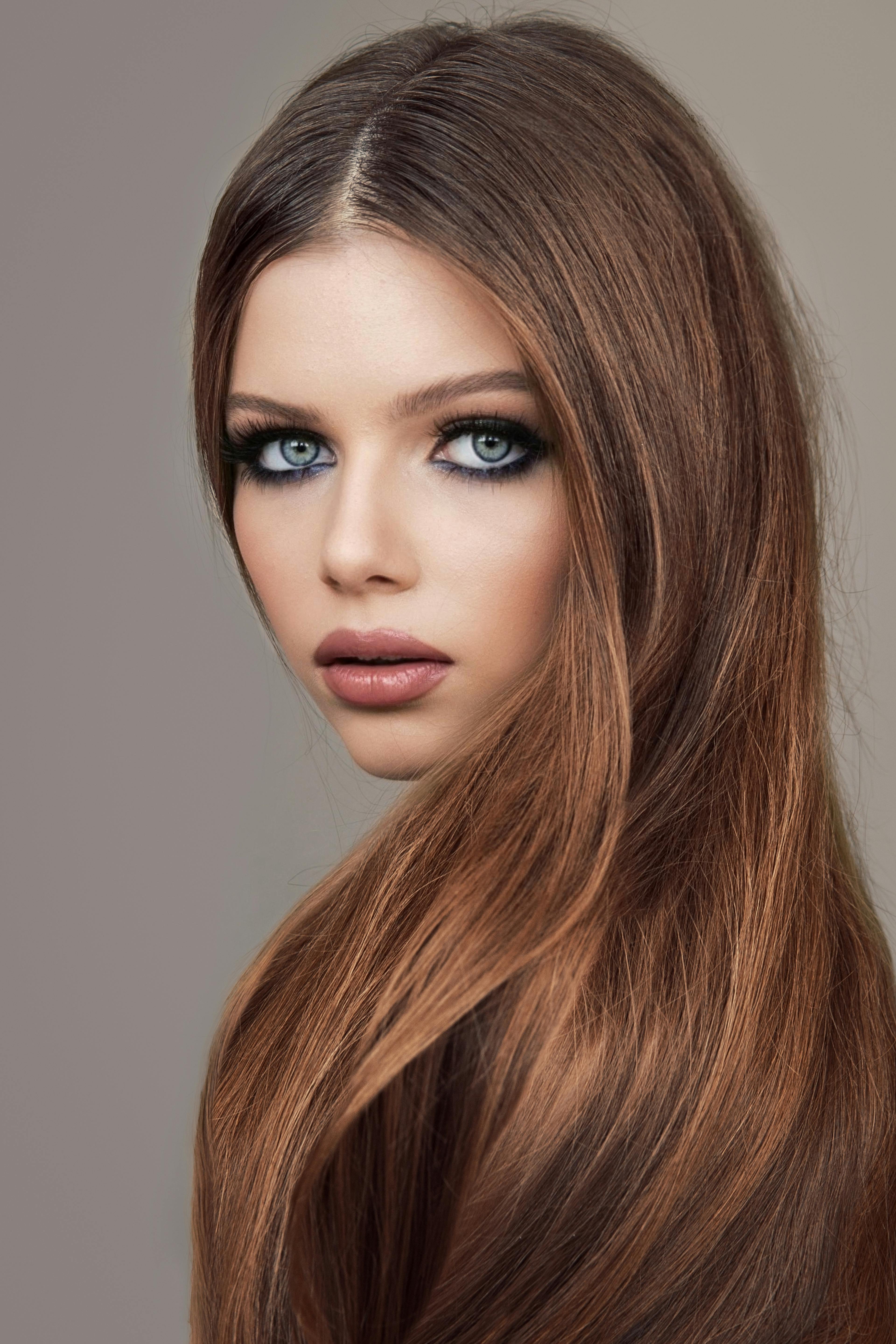 person with auburn hair staring into camera