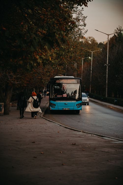 Free Bus and pedestrians on a city street in Ankara, Türkiye during fall. Stock Photo
