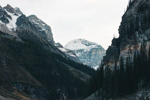 Breathtaking view of snow-capped mountains framing Lake Louise, Canada.