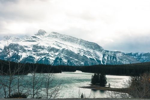 Free Explore the serene beauty of Banff with a stunning mountain and lake view during winter. Stock Photo