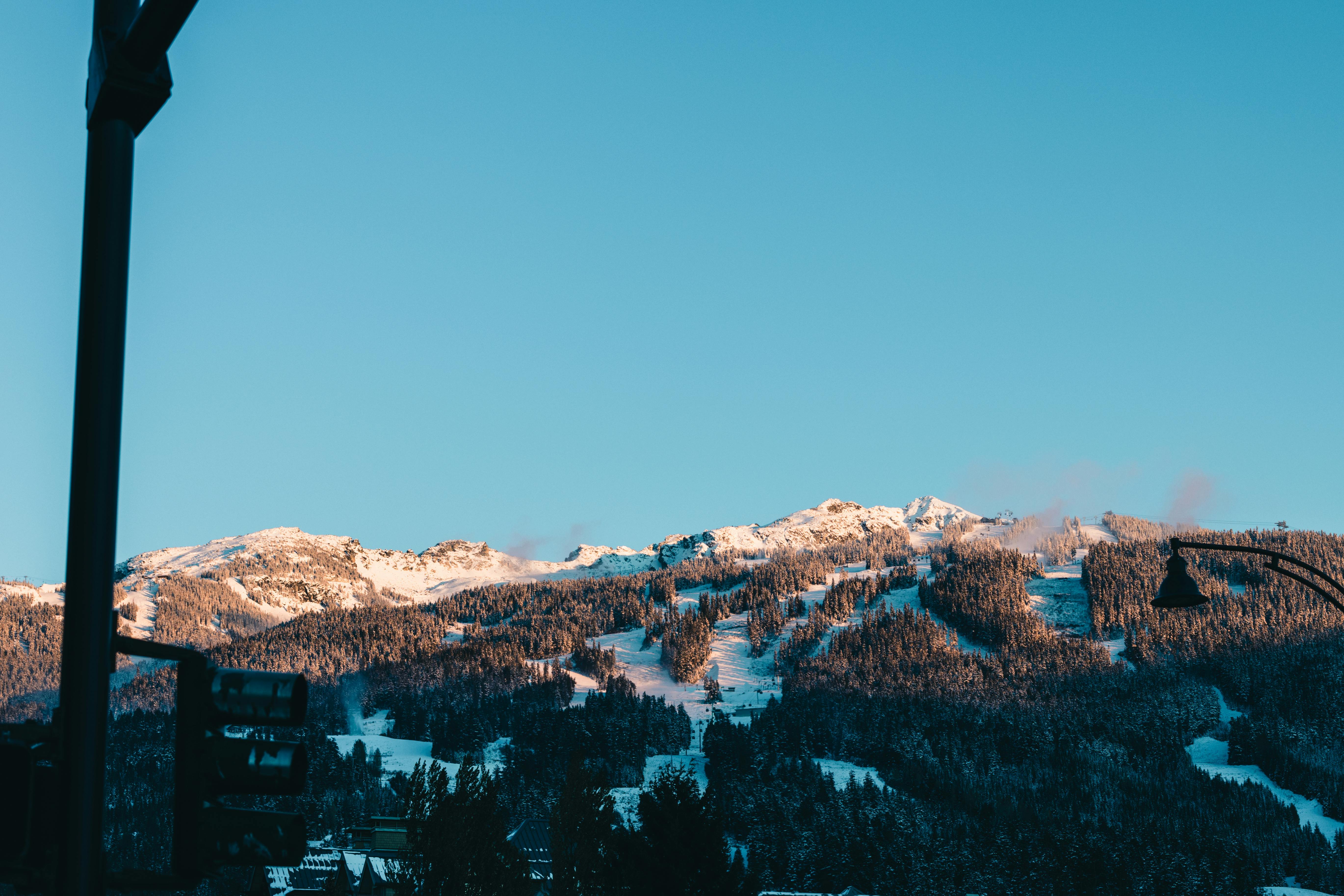 Prescription Goggle Inserts - Explore the stunning winter landscape of Whistler with snow-covered mountains and clear blue skies.