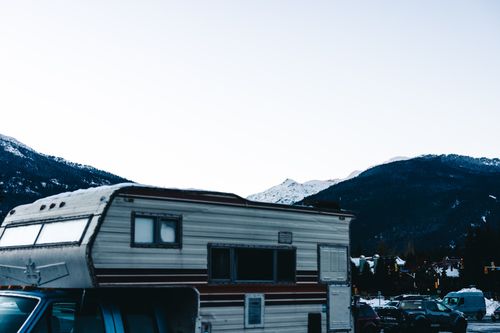 Free RV camping in snowy Whistler, BC with a stunning mountain backdrop. Stock Photo