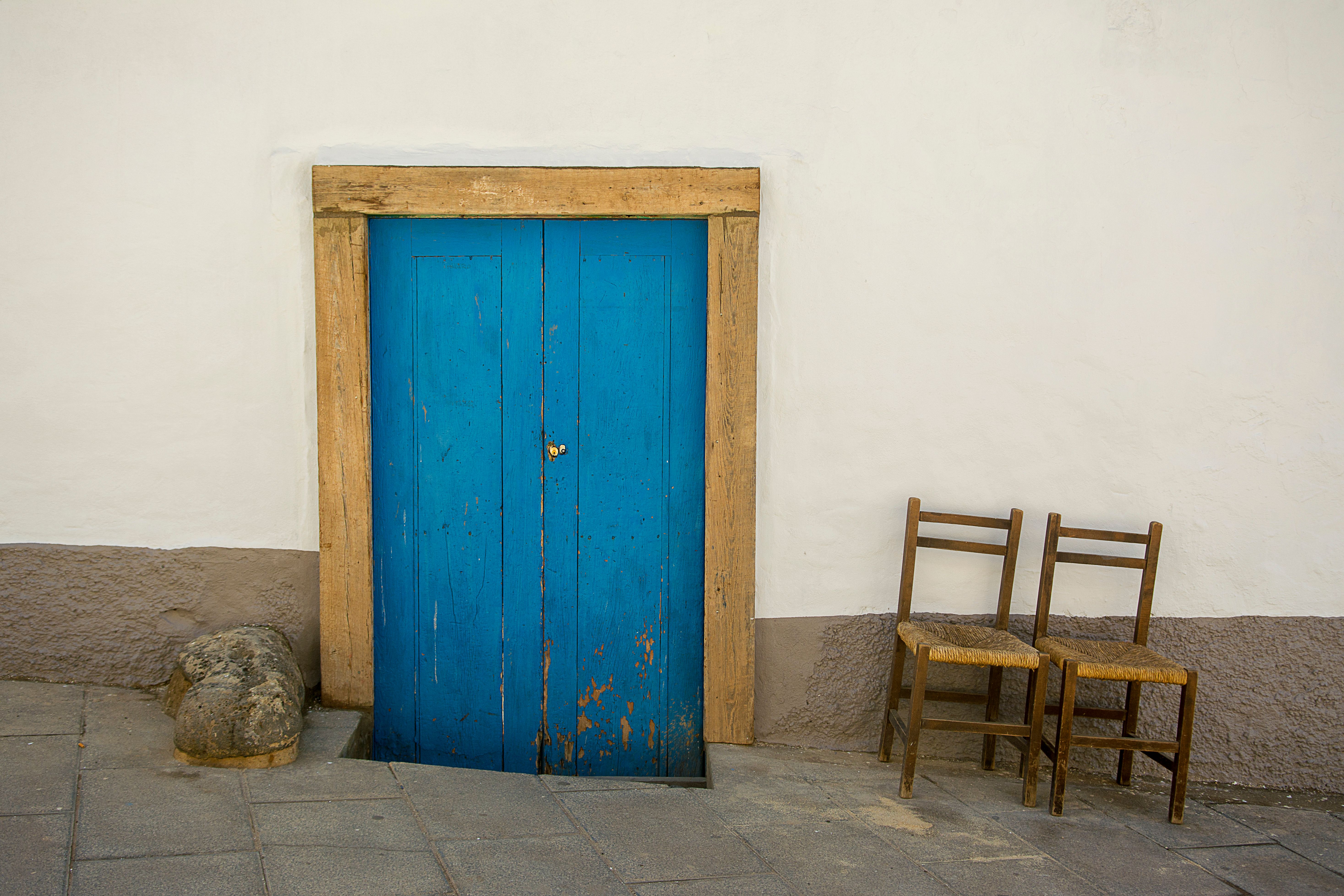 Blue Wooden Door and Old Chairs in front of a Building · Free Stock Photo