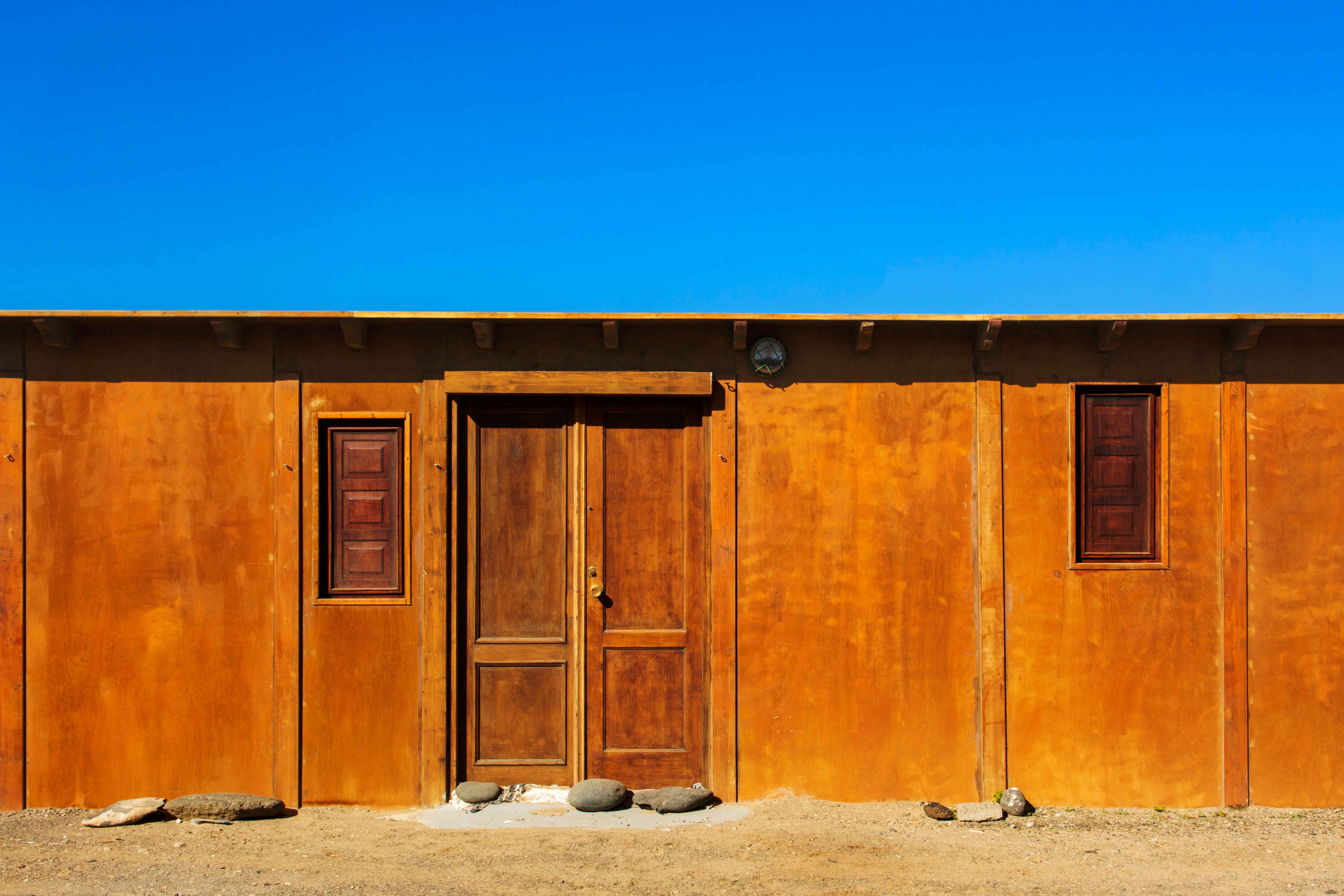 Facade and a Wooden Building under Blue Sky