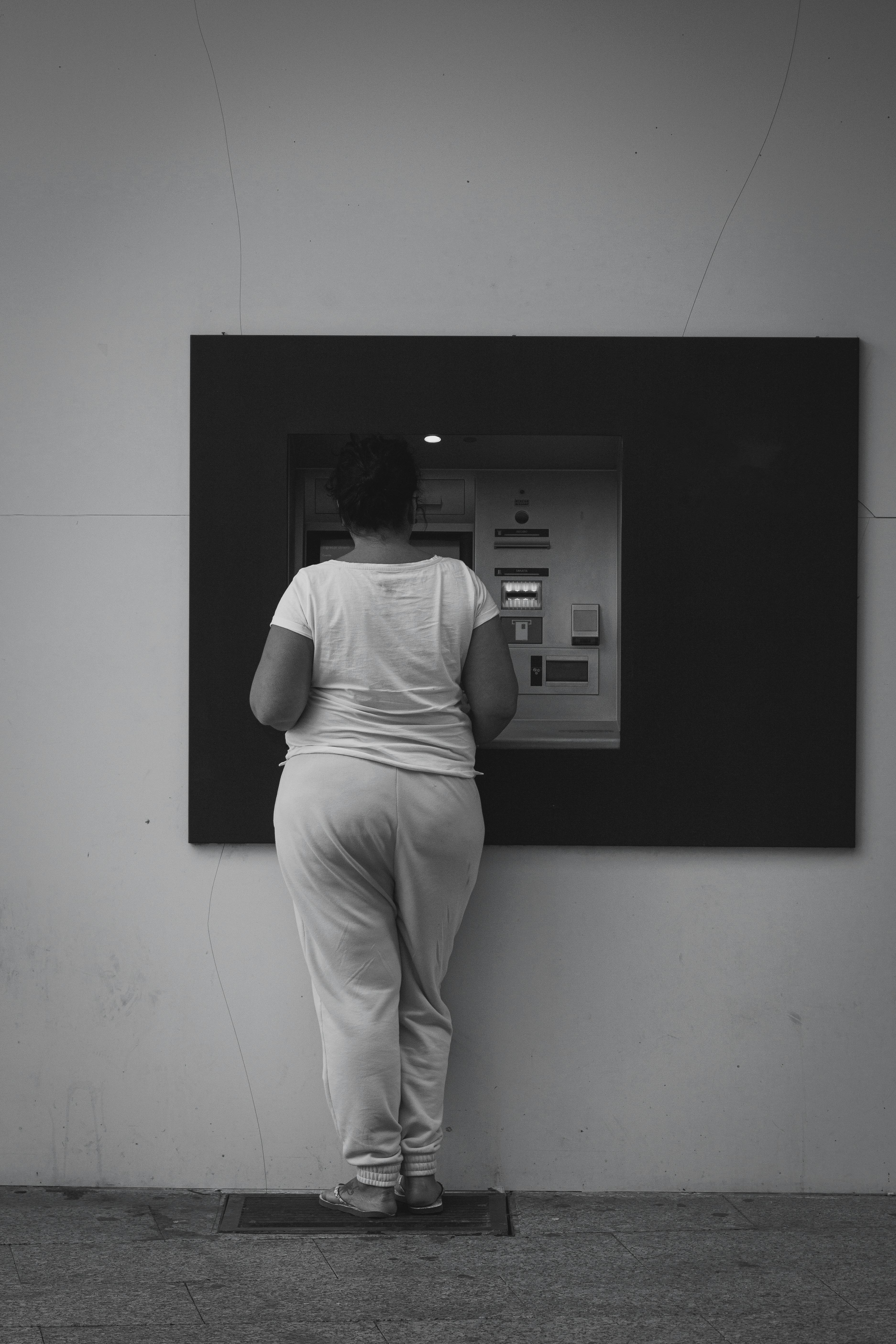 woman taking money from cash machine