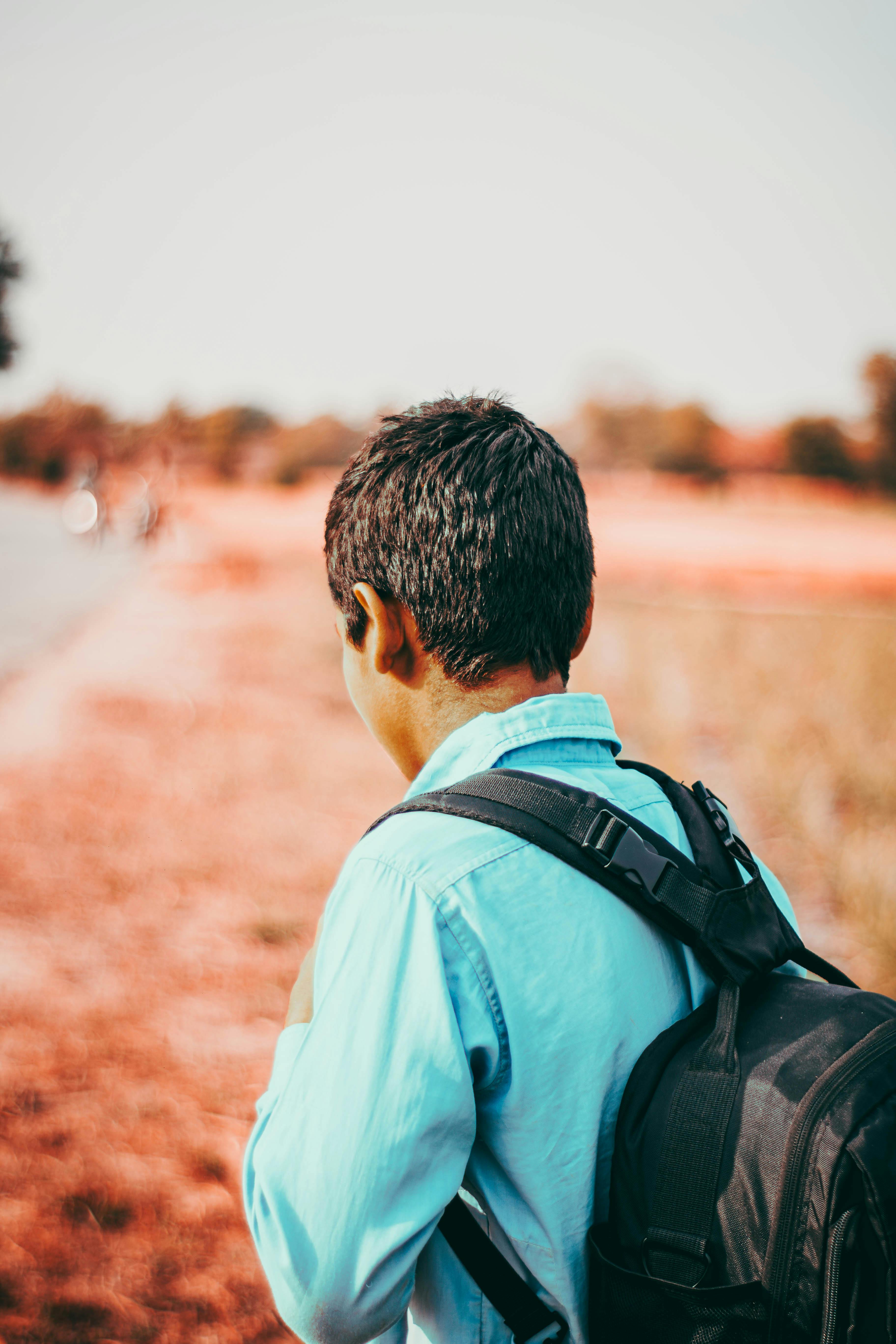 Back of a Boy Wearing a Backpack · Free Stock Photo