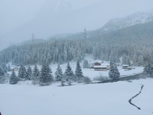 Free Snow-covered forest and cabins in a tranquil winter setting. Stock Photo